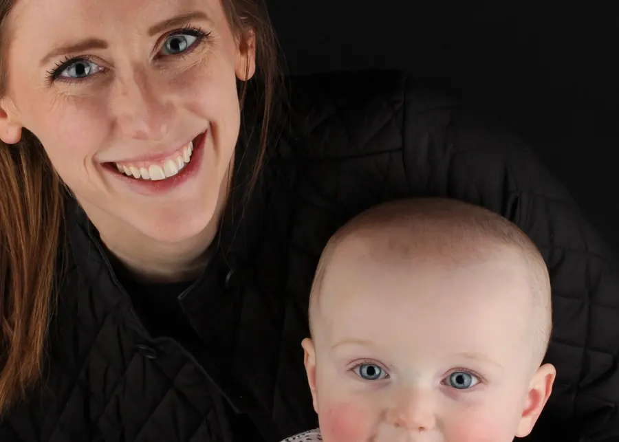 A mother holding her smiling baby.